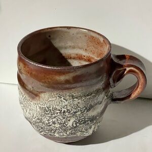 Rustic Brown and Cream Ceramic Mug by unknown artist.
